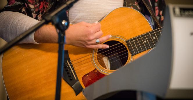 Close up of a guitar being played