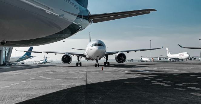 Photo of airplanes lines up on tarmac waiting to take off