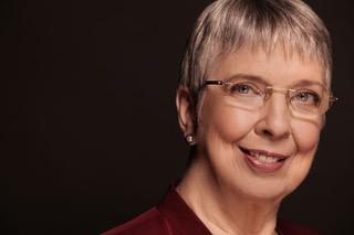 Woman with short grey hair and glasses